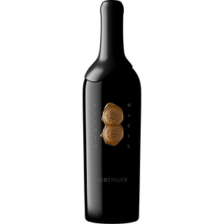 Black wine bottle with gold foil label on a white background