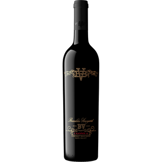 Black wine bottle with gold and red label on a white background